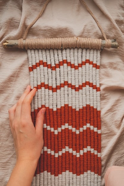 A detailed photograph of Navajo weaving, showing intricate patterns and natural dyes, perhaps with a weaver's hands at work.