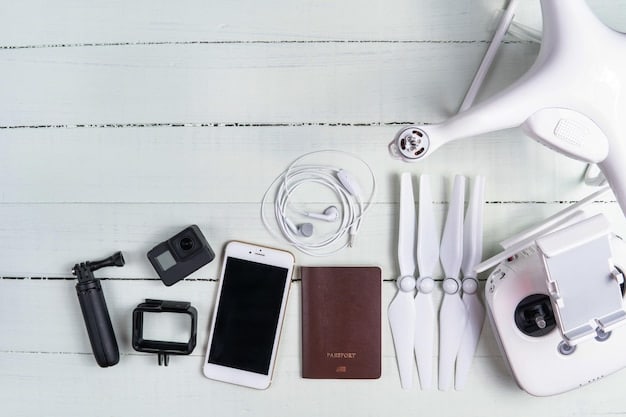 A neatly arranged collection of travel electronics on a packing cube, including a smartphone, a portable charger, charging cables, and noise-canceling headphones, demonstrating organized tech packing.
