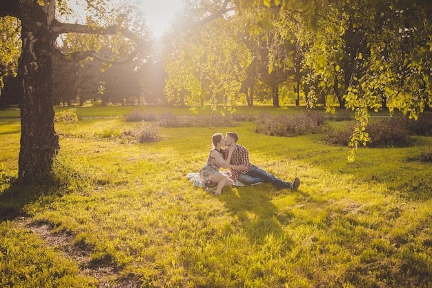 A couple enjoying a serene picnic in a lush park, surrounded by tall trees and dappled sunlight, symbolizing relaxation and intimacy.