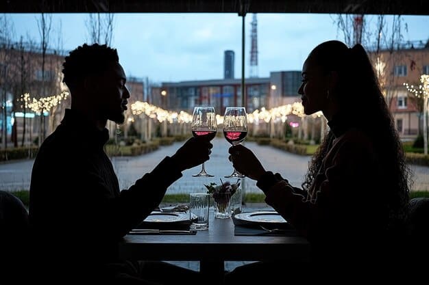 A couple toasting with wine glasses at a beautifully set outdoor restaurant table, with city lights subtly blurred in the background, conveying a romantic dining experience.