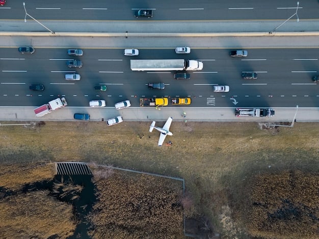 A drone shot of a busy land border crossing with multiple lanes for cars and trucks, showing a mix of commercial and private vehicles moving through inspection points under clear skies.