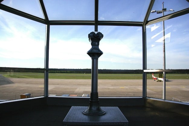 A sleek, modern air traffic control tower with panoramic windows overlooking a bustling airport, showing aircraft taking off and landing, with a clear blue sky, symbolizing advanced operations and efficiency.