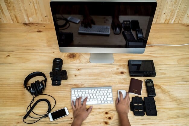 An editor's hands poised over a keyboard and mouse, surrounded by multiple large monitors displaying complex video editing software timelines and color grading panels, highlighting the intricate nature of post-production.