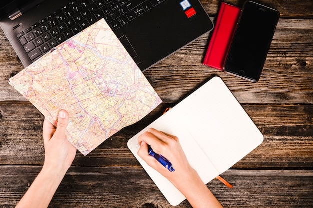 A person meticulously arranging travel cards, maps, and notes on a large table, symbolizing detailed itinerary planning and optimization.