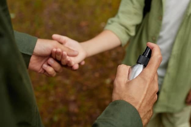 A person's hand applying antiseptic spray to a small cut on another person's arm while traveling outdoors, emphasizing practical travel first aid.