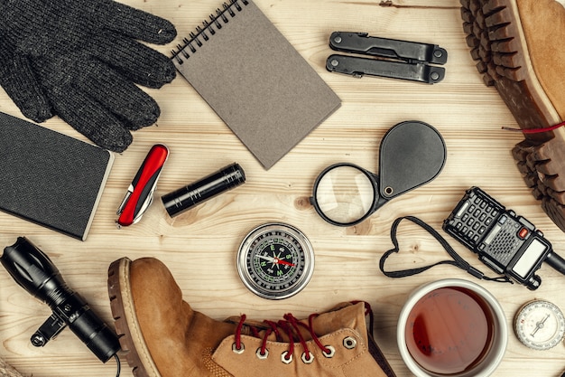 A detailed close-up of a well-organized survival backpack, showcasing essential tools like a compass, knife, and first aid kit, arranged for quick access.