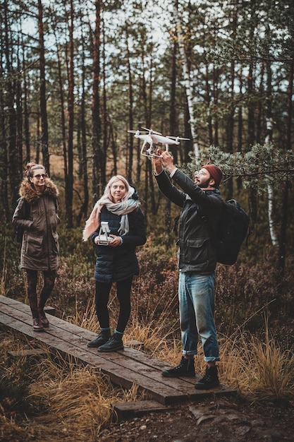 A group of excited travelers, equipped with binoculars and field guides, observing a herd of majestic elk in a vast, sun-drenched valley within a national park.
