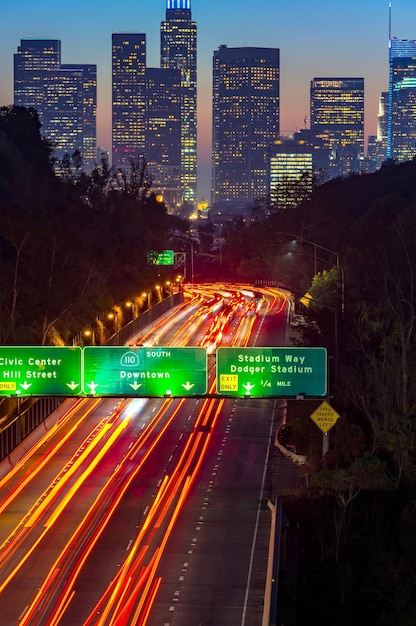 A screenshot of Google Maps displaying real-time traffic information in a major US city during rush hour. The map shows various routes highlighted in different colors to indicate traffic density, with icons for nearby points of interest. The phone screen is clear and bright, emphasizing the app's user-friendly interface.