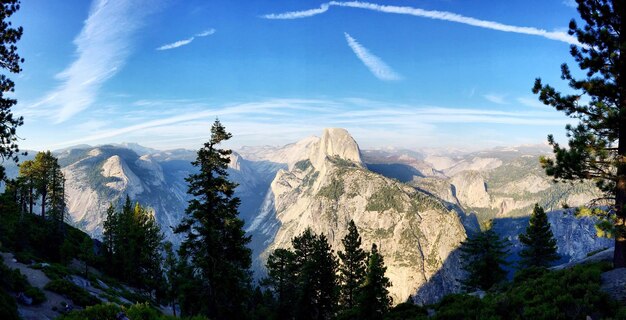 A panoramic view from the top of a lesser-known mountain peak in Montana, showing vast, untouched wilderness with no signs of human development or crowds. The sun is setting, casting a golden glow over the landscape, emphasizing the solitude and raw beauty of nature away from popular tourist destinations, directly relating to Avoiding Tourist Traps: A 2025 Guide to Authentic US Experiences.