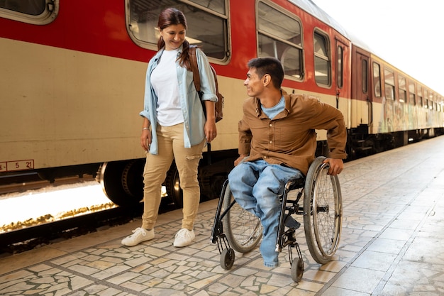 A family with a member using a wheelchair is happily boarding a train. The train has a visible ramp for easy access. The scene represents accessible transportation options available for travelers with disabilities in the US, in line with The Complete Guide to Accessible Travel in the US: Updated for 2025.
