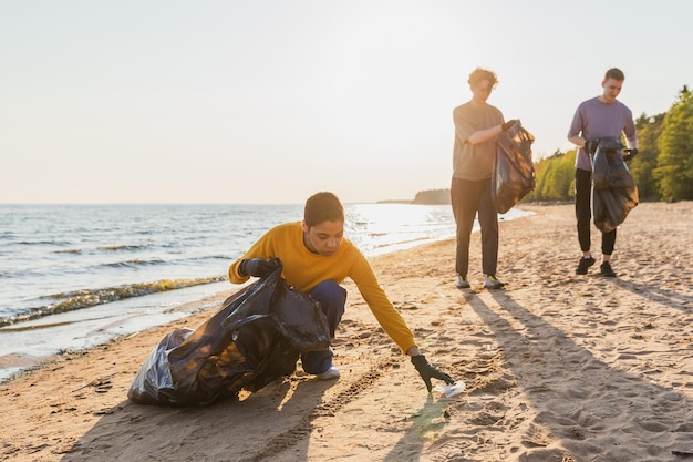 A traveler participating in a community clean-up effort on a beach in Oregon. The image showcases active involvement in preserving the environment, emphasizing 'Sustainable Travel in the US: A 2025 Guide to Eco-Friendly Adventures'.