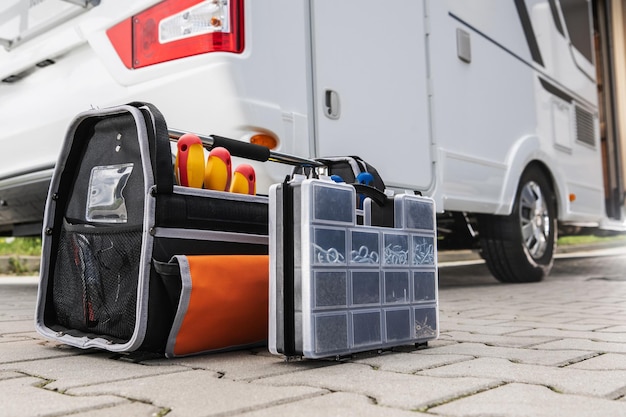 An organized RV storage compartment filled with essential gear and accessories, including leveling blocks, water hoses, electrical adapters, and tool kits. The image emphasizes the importance of being well-prepared for RV Travel in the US: A Beginner's Guide to Hitting the Road in 2025.