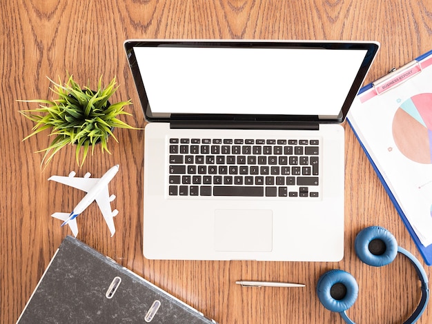 An overhead shot of a laptop displaying a travel booking website, with various flight and hotel options, alongside a credit card and a coffee cup. The scene represents the planning and booking of a trip using points earned from Credit Card Sign-Up Bonuses: Earn 100,000 Points or More with These Limited-Time Offers.