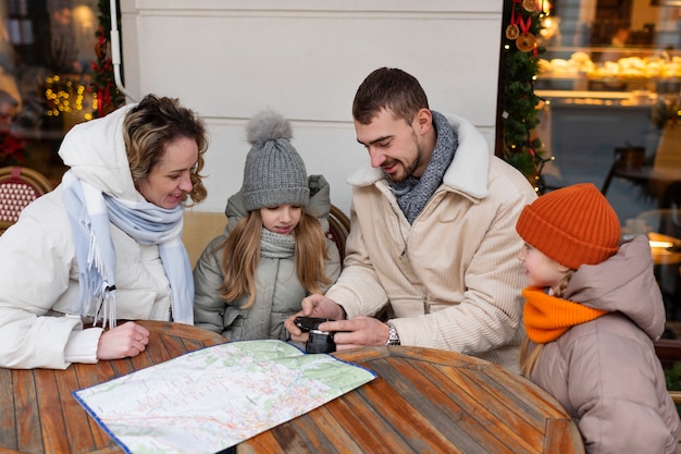 A family is depicted sitting together at a table, reviewing a travel plan displayed on a tablet. They are smiling and engaged in a discussion about their upcoming vacation, showing the collaborative aspect of Points Pooling Strategies.