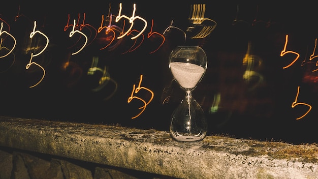 A vintage-style hourglass with points and miles flowing through it, symbolizing the urgency of using rewards before they lose value. The background consists of blurred images of travel destinations, enhancing the travel rewards context. 'Points and Miles Devaluation: How to Protect Your Rewards in 2025' is subtley embedded in the image.