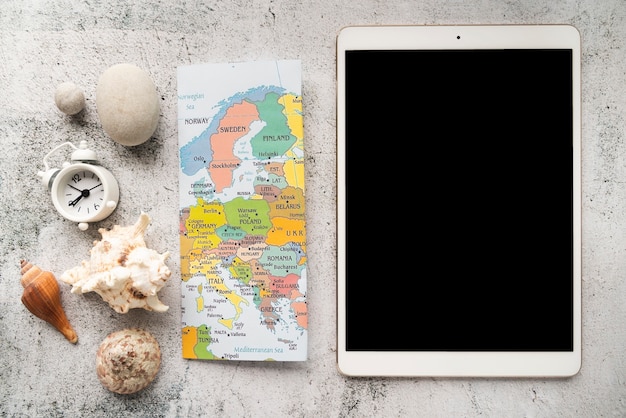 A world map displayed on a tablet, indicating popular travel destinations, surrounded by credit cards, airline tickets, and hotel key cards. This visuals emphasizes the travel-related advantages of Points Transfer Partners: Convert Rewards Between Programs for Maximum Flexibility in 2025.