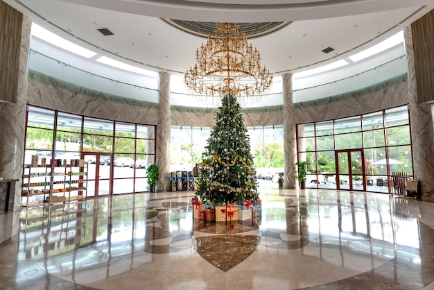 A modern hotel lobby during the holiday season. The space is decorated with festive decorations, and guests are checking in and out. The scene represents the hotel industry's role in accommodating holiday travelers, prompting the question: Is the US Travel Industry Prepared for the 7% Increase in Holiday Travelers Expected in 2025?