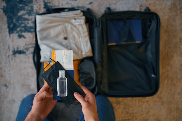 A close-up shot of a traveler packing their carry-on bag with liquids and gels in a clear, quart-sized bag, along with a laptop and other electronic devices. The traveler is carefully organizing the items according to TSA guidelines, ensuring a smooth and efficient security screening process. The scene demonstrates practical steps travelers can take to comply with New TSA Security Protocols: What Travelers Need to Know Before Their Next Flight in 2025.