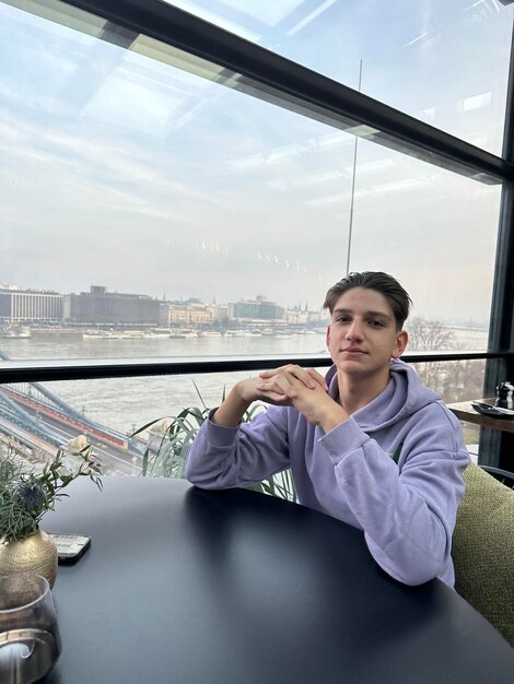 A person sitting in a hotel room, looking out the window with a concerned expression, representing the quarantine period covered by updated travel insurance policies. This exemplifies Travel Insurance Updates: Understanding the New Coverage Options for Pandemic-Related Disruptions.