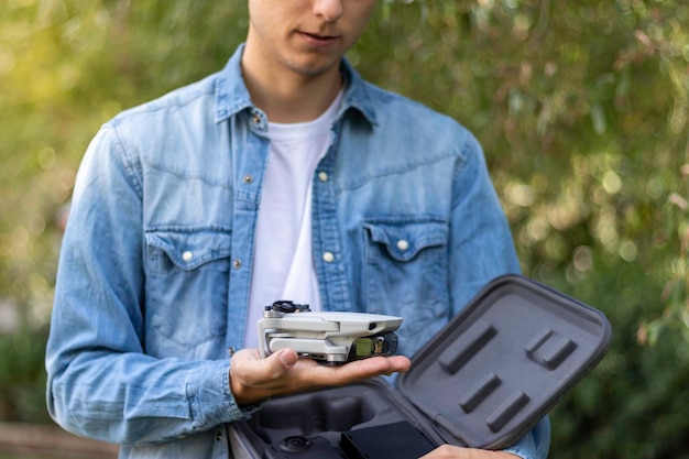 A photographer inspecting their drone, highlighting the pre-flight checklist and maintenance required to ensure compliance with FAA regulations and safe operation in travel photography settings as we ask again 
