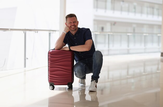 A worried traveler sitting alone in an airport, surrounded by delayed luggage, illustrating the potential challenges of travel and the need for insurance coverage. The scene is monochrome to emphasize the feeling of stress and uncertainty. A subtle text overlay reads: 