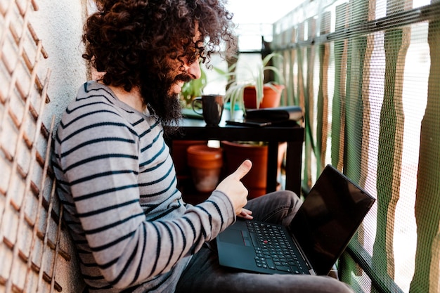 A digital nomad reviewing spreadsheets on a laptop in a cafe, while also using a mobile banking app on their phone. The scene highlights the importance of financial management and the use of digital tools for budgeting and tracking expenses while traveling. This image represents a critical part of 