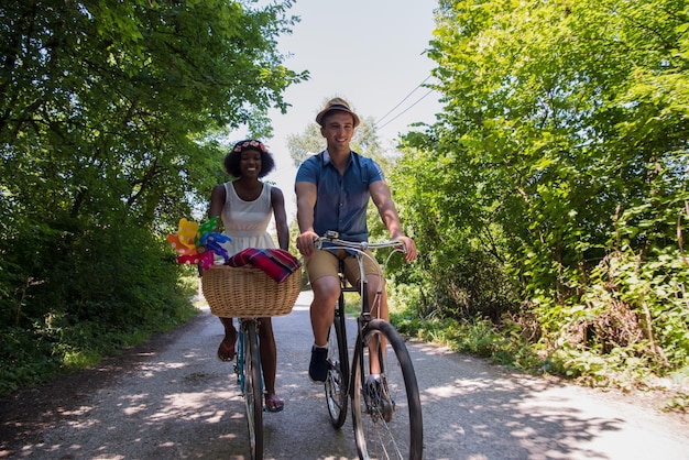 A vibrant scene of diverse people riding bicycles along a scenic bike path in a city park, with lush trees and green spaces flanking the path. The image showcases Sustainable Travel Practices: Reduce Your Carbon Footprint and Travel Responsibly by promoting active and eco-friendly transportation.