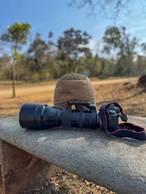 A detailed shot of camera gear, including a DSLR/mirrorless body, various lenses, a tripod, and ND filters laid out on a rugged outdoor surface, suggesting preparation for a shoot.